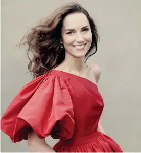  ?? ?? The Duchess of Cambridge in a red asymmetric off-shoulder McQueen dress and earrings loaned by the Queen. Photograph: Paolo Roversi/PA Photograph: Paolo Roversi/PA