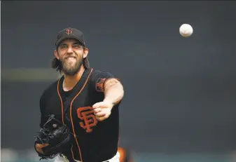  ?? Ross D. Franklin / Associated Press ?? The Giants’ Madison Bumgarner threw six shutout innings against the Angels at Scottsdale Stadium. The left-hander allowed one hit and one walk. Bumgarner threw 70 pitches.