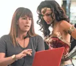  ?? ENOS/WARNER BROS. CLAY ?? Director Patty Jenkins, left, with actress Gal Gadot on the set of “Wonder Woman 1984.”