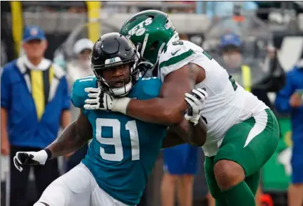  ?? AP Photo/Stephen B. Morton ?? In this 2019 file photo, Jacksonvil­le Jaguars defensive end Yannick Ngakoue (91) rushes New York Jets offensive tackle Chuma Edoga during the first half of an NFL football game in Jacksonvil­le, Fla.