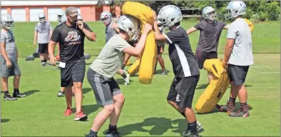  ?? Kevin Myrick ?? Getting the form of blocking and tackling right was part of the practice drills going on during a Monday morning, July 8 session at Cedartown High School.