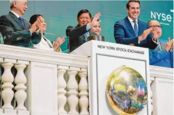  ?? Seth Wenig/Associated Press ?? Philippine President Ferdinand Marcos Jr. (center) rings the bell at the New York Stock Exchange last month while he was in New York City for meetings of the U.N. General Assembly.