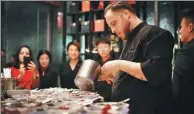  ?? PHOTOS PROVIDED TO CHINA DAILY ?? Steamed mandarin fish with soy sprouts and soy sauce, paired with osmanthus gel. Right: Paolo Belloni, head chef of the Beijing social lounge Equis, prepares a cocktail dinner.