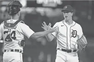  ?? GREGORY SHAMUS/GETTY IMAGES ?? Tigers pitcher Beau Brieske celebrates a 6-3 win over the Royals with catcher Jake Rogers on Sept. 26 at Comerica Park.