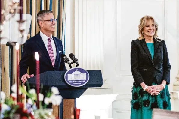  ?? Andrew Harnik / Associated Press ?? White House social secretary Carlos Elizondo, accompanie­d by first lady Jill Biden, speaks during a media preview Nov. 30 for the State Dinner with President Joe Biden and French President Emmanuel Macron in the State Dining Room of the White House in Washington.