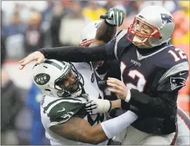  ?? CHARLES KRUPA — ASSOCIATED PRESS ARCHIVES ?? In this Dec. 24, 2016, file photo, New York Jets defensive end Sheldon Richardson, left, hits New England Patriots quarterbac­k Tom Brady (12) after he released a pass.