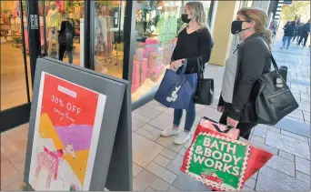  ?? Dan Watson/ The Signal ?? Shoppers Caitlyn, left, and Cathy Zimmerman look for bargains at the Westfield Valencia Town Center on Friday.