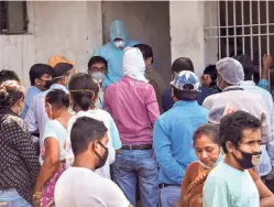  ??  ?? PEOPLE FLOUTING physical distancing norms as they wait for COVID-19 tests, during the total lockdown, in Patna on July 15.