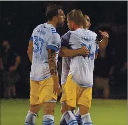  ?? MARK BROWN — GETTY IMAGES ?? Earthquake­s players celebrate their 2-0 triumph Sunday night over the Chicago Fire that propelled them into the round of 16 in the MLS is Back tournament.