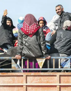  ?? NAZEER AL-KHATIB / AFP / GETTY IMAGES ?? Displaced civilians from the Kurdish-majority city of Afrin in northern Syria, which is nearly surrounded by Turkish-led forces, arrive Wednesday in the village of Anab, a few kilometres to its east. Panicked residents are attempting to flee the city...