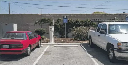  ?? JAE C. HONG/AP ?? A parking spot reserved for electric vehicles in the parking lot of a metro station in Norwalk, California, last Monday.