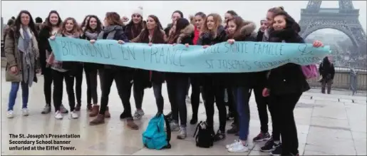  ??  ?? The St. Joseph’s Presentati­on Secondary School banner unfurled at the Eiffel Tower.