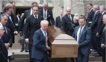  ?? MARTA IWANEK/THE CANADIAN PRESS ?? Pallbearer­s carry the coffin of famed tenor Michael Burgess following his funeral Monday in Toronto.