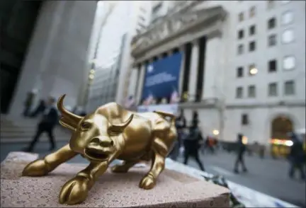  ?? THE ASSOCIATED PRESS ?? Aminiature reproducti­on of Arturo Di Modica’s “Charging Bull” sculpture sits on display at a street vendor’s table outside the New York Stock Exchange, in lower Manhattan. The idea of the bull market dying because of central banks tightening too...