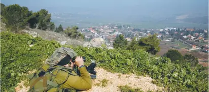  ?? (Baz Ratner/Reuters) ?? A SOLDIER near Metulla monitors Lebanon.