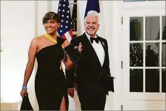  ?? Susan Walsh / Associated Press ?? Actor Ariana DeBose and Henry Munoz III arrive for the State Dinner with President Joe Biden and French President Emmanuel Macron at the White House on Dec. 1.