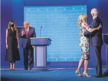  ?? Washington Post ?? First lady Melania Trump and Jill Biden join their husbands on the stage following Thursday night’s final presidenti­al debate in Nashville, Tennessee.