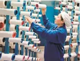  ?? AFP/ GETTY IMAGES ?? A woman works at a textile factory in Haian in China’s eastern Jiangsu province.