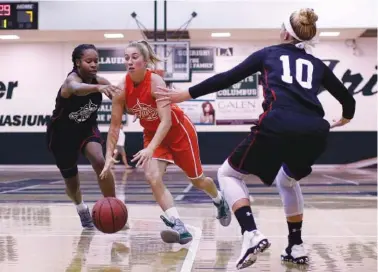  ?? STAFF PHOTO BY DOUG STRICKLAND ?? Tennessee’s Emily Harkleroad, center, drives between Georgia’s Karoline Sholl (10) and Jazzmyn Elston during the girls’ high school all-star basketball game at Notre Dame High School on Tuesday. Tennessee won 70-53.