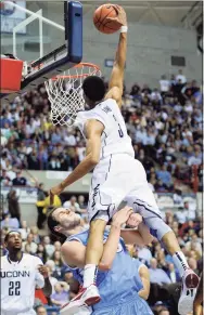  ?? Fred Beckham / Associated Press ?? UConn’s Jeremy Lamb, top, dunks over Columbia's Mark Cisco during a 2011 game.