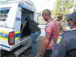  ??  ?? Police arrest two men who refused to adhere to the rules of the lockdown in Diepsloot Extension 12.