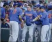  ?? NATI HARNIK — ASSOCIATED PRESS ?? Florida’a Deacon Liput (8), is mobbed by teammates after he hit a three-run home run against Louisville’s Kade McClure during the fourth inning June 20 at the College World Series.