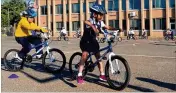  ?? MARIA DANILOVA / AP ?? Second-graders learn to ride bikes at Seaton Elementary School in Washington. At a time when elementary and high schools are all about getting students ready for college or jobs, physical education teachers are being urged to look beyond graduation, too.