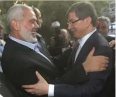  ?? ASHRAF AMRA/THE ASSOCIATED PRESS FILE PHOTO ?? Hamas’s Prime Minister Ismail Haniyeh, left, welcomes the foreign minister of Turkey, Ahmet Davutoglu, in Gaza City last month.