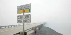  ?? — Reuters ?? Smoke from the Carr Fire shrouds the Clear Creek Bridge near Igo, California.