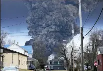  ?? GENE J. PUSKAR — THE ASSOCIATED PRESS ?? A black plume rises over East Palestine, Ohio, as a result of a controlled detonation of a portion of the derailed train on Monday.