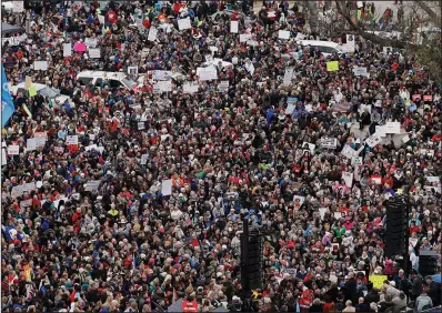  ?? AP/SUE OGROCKI ?? A crowd listens to speakers on a stage, lower right, during a teacher rally to protest low education funding at the state Capitol on Monday in Oklahoma City.