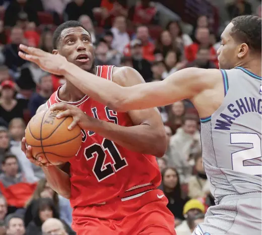  ?? NAM Y. HUH/AP ?? Thaddeus Young, who got more playing time Friday night, drives to the basket as Hornets forward P.J. Washington defends in the second half at the United Center.