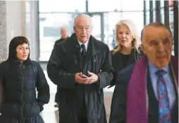  ?? JOSE M. OSORIO/CHICAGO TRIBUNE ?? Former Chicago Ald. Edward Vrdolyak, center, departs the Dirksen U.S. Courthouse with his lawyer, Michael Monico, after he pleaded guilty March 7, 2019, to a federal tax evasion charge stemming from millions of dollars in payments he received from the state’s massive settlement with tobacco companies in the 1990s.