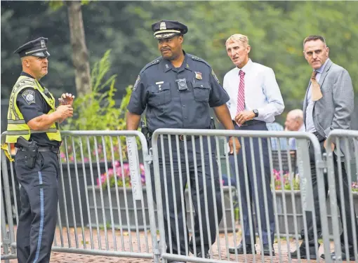  ?? SCOTT EISEN, GETTY IMAGES ?? Boston police Chief William Gross, second left, Commission­er William Evans, second right, and other officers confer on Boston Common, where thousands of counterpro­testers overwhelme­d a “Free Speech” rally Saturday.