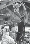  ?? MIC SMITH/AP ?? Northeaste­rn’s Anthony Green dunks against Hofstra’s Jacquil Taylor in the Colonial Athletic Associatio­n title game March 12.