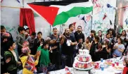  ??  ?? UNITED: A man holds a Palestinia­n flag as people take part in an event ahead of the anniversar­y of the Balfour Declaratio­n outside Banksy’s Walled Off Hotel.