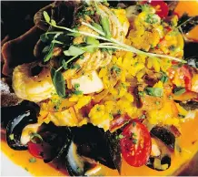  ??  ?? Seafood paella is one stalwart that is back on the new menu.