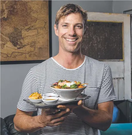  ?? Picture: JERAD WILLIAMS ?? Cameron Chartres, owner of Stones Throw, with popular Korean dish bibimbap..