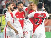  ??  ?? Monaco's Colombian forward Radamel Falcao (2ndL) celebrates with Kylian Mbappe Lottin and others after scoring a goal during the football match against Lille.