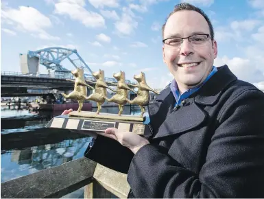  ??  ?? Jordan Bateman, B.C. director of the Canadian Taxpayers Federation, with the 2017 Municipal Teddy Government Waste Award for Victoria’s Johnson Street Bridge project. “I feel terrible for the taxpayers of Victoria,” Bateman said.