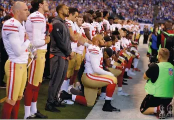  ?? MICHAEL CONROY/AP PHOTO ?? Members of the San Francisco 49ers kneel during the playing of the national anthem before an NFL football game against the Indianapol­is Colts on Sunday in Indianapol­is. Vice President Mike Pence left the 49ersColts game after about a dozen San...