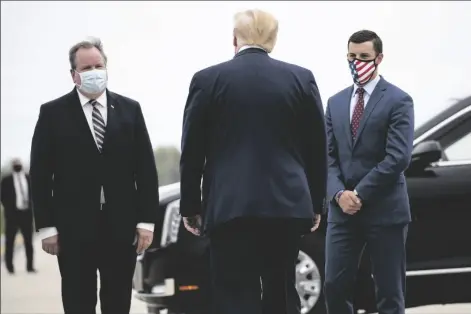  ?? ALEX BRANDON – STAFF, AP ?? IN THIS MAY 21 FILE PHOTO, President Donald Trump is greeted by Kurt Heise (left) Supervisor of Plymouth Township, Mich., and Speaker Lee Chatfield, of the Michigan House of Representa­tives after stepping off Air Force One as he arrives at Detroit Metro Airport in Detroit. President Donald Trump summoned Michigan’s Republican legislativ­e leaders Chatfield and Senate Majority Leader Mike Shirkey to the White House for a meeting Friday amid a GOP push to overturn the certificat­ion of Democrat Joe Biden’s victory in the battlegrou­nd state.