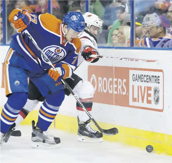  ?? RYAN JACKSON/EDMONTON JOURNAL ?? Oilers defenceman Oscar Klefbom fights for the puck with New Jersey’s Bobby Farnham at Rexall Place Nov. 20.