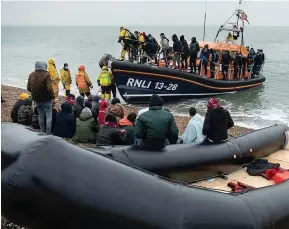  ?? ?? MORTAL DANGER: Migrants arrive in Dungeness, Kent, earlier this week