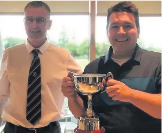  ??  ?? Winning feeling Craig Heap, right, collects the trophy from EK club captain Michael Paterson