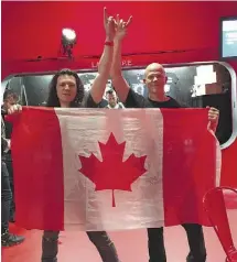  ??  ?? Two Striker fans in Berlin sport a Canadian flag.