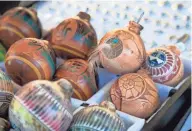  ?? PHOTOS BY CHERYL EVANS/THE REPUBLIC ?? Clay Christmas ornaments are for sale at the Navajo craft market off 89A in Sedona.