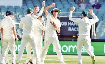  ??  ?? Australia’s Pat Cummins (C) grabbed internatio­nal attention with his spectacula­r run out. - AFP photo