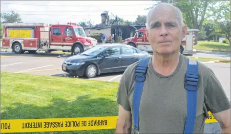  ?? DAVE STEWART/THE GUARDIAN ?? Jock Beck, deputy chief of the Montague Fire Department, is shown near the charred remnants of the Montague Town Hall which was destroyed by fire early Thursday morning. While the building’s shell remains, Beck said it will have to be demolished.