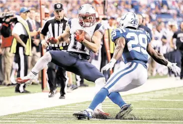  ?? AJ Mast / Associated Press ?? Patriots receiver Julian Edelman, left, puts on the brakes when encounteri­ng Colts safety Mike Adams, but there was no stopping the New England offense on Sunday night.